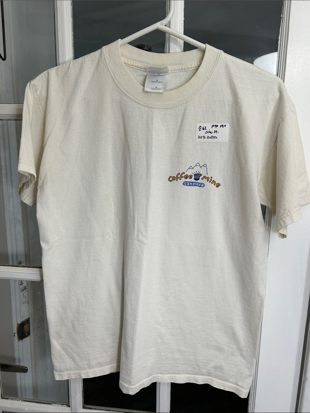 O62.    Gildan.Cream Short-Sleeve Tee with Mountain Coffee Graphic